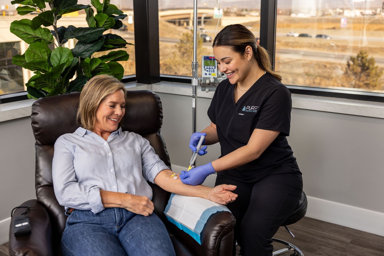 A Pure Infusion nurse preparing a patient's infusion