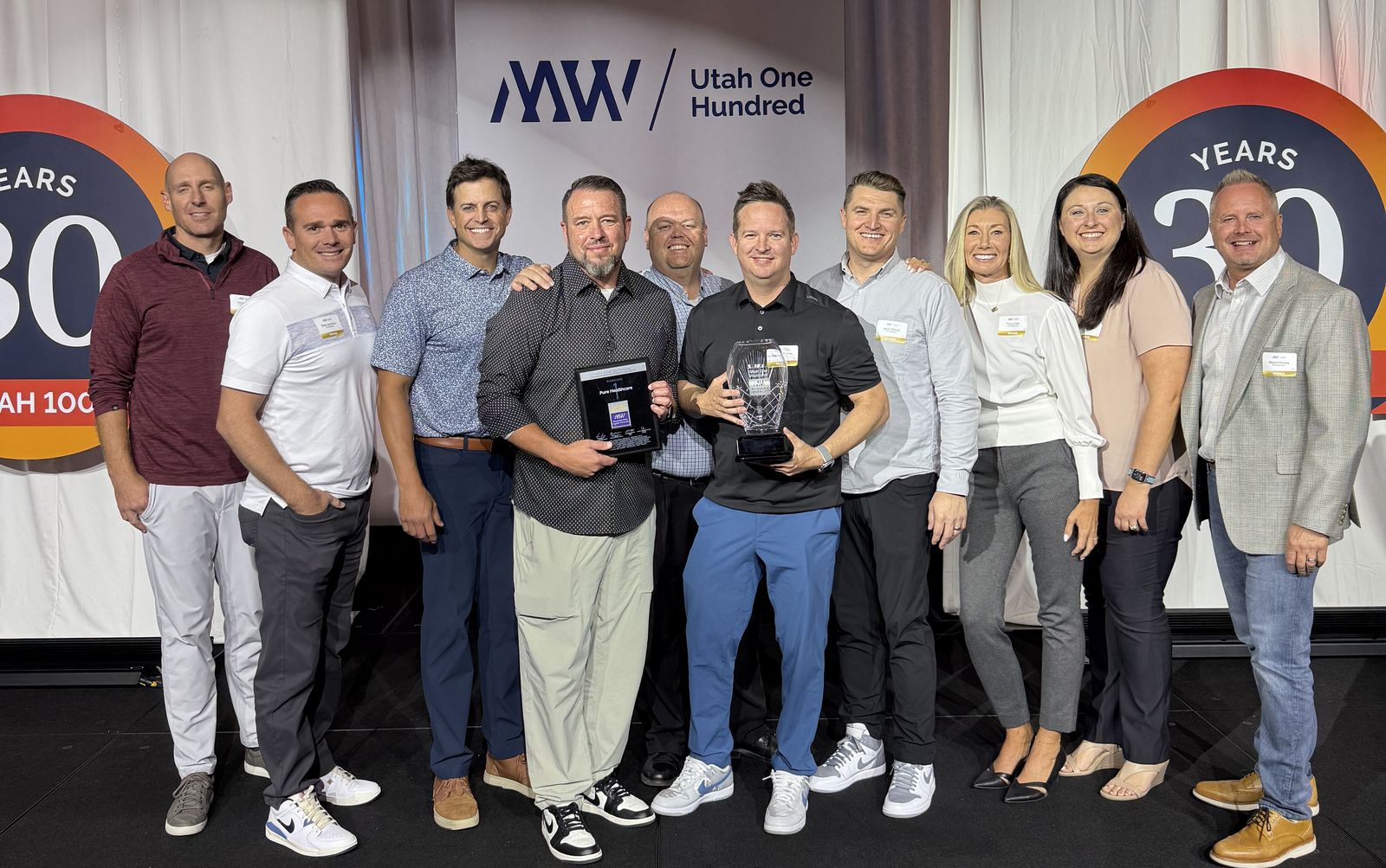 The Pure Infusion team on stage with the award at MWCN's Utah One Hundred, October 2, 2024